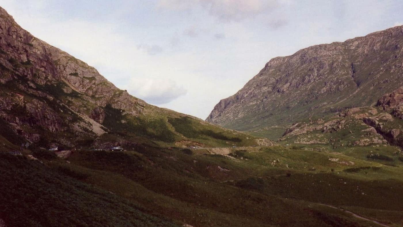 A steep rocky pass between two hills, with a track running through the moorland at its foot.