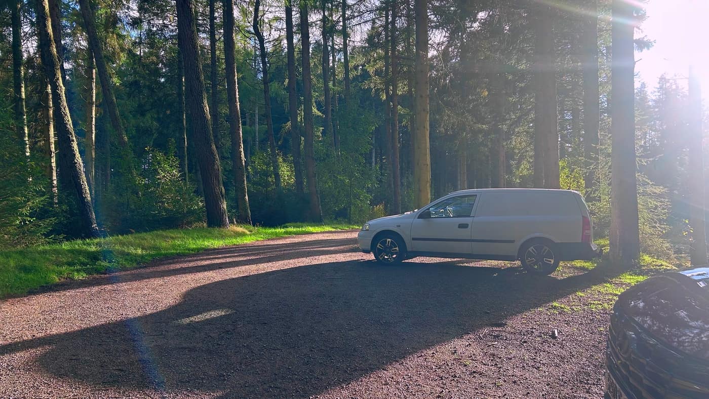 The gravel car park in the trees off the A95, the van and one other car in it