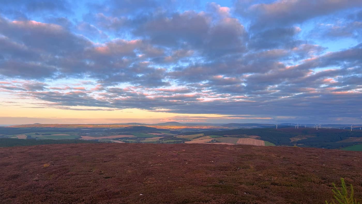 The light moving across the fields, windmills along the ridge