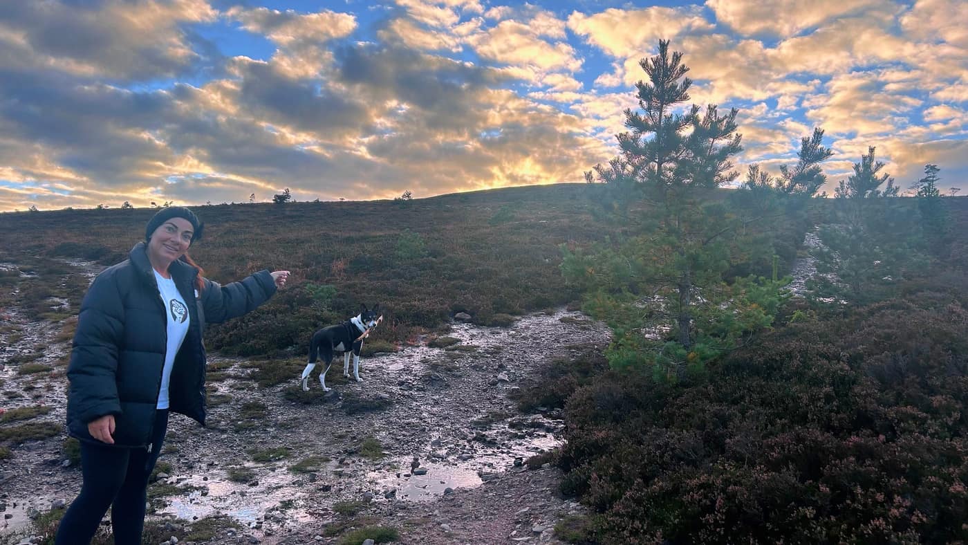 Katrina and Chase on the open hill, the top in sight