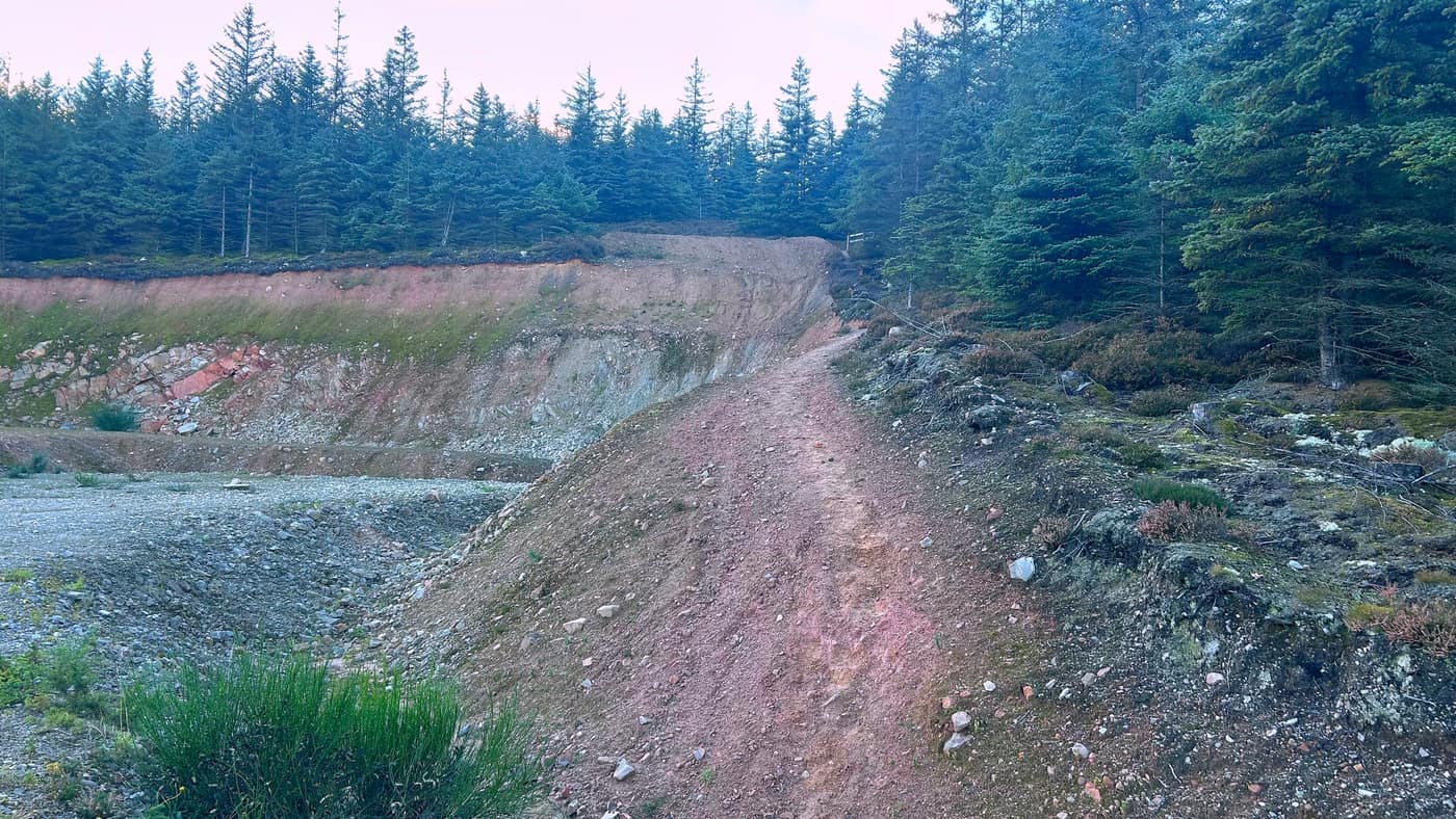 The quarry — a big scoop out of the hillside, the rock pink, the path running up the middle