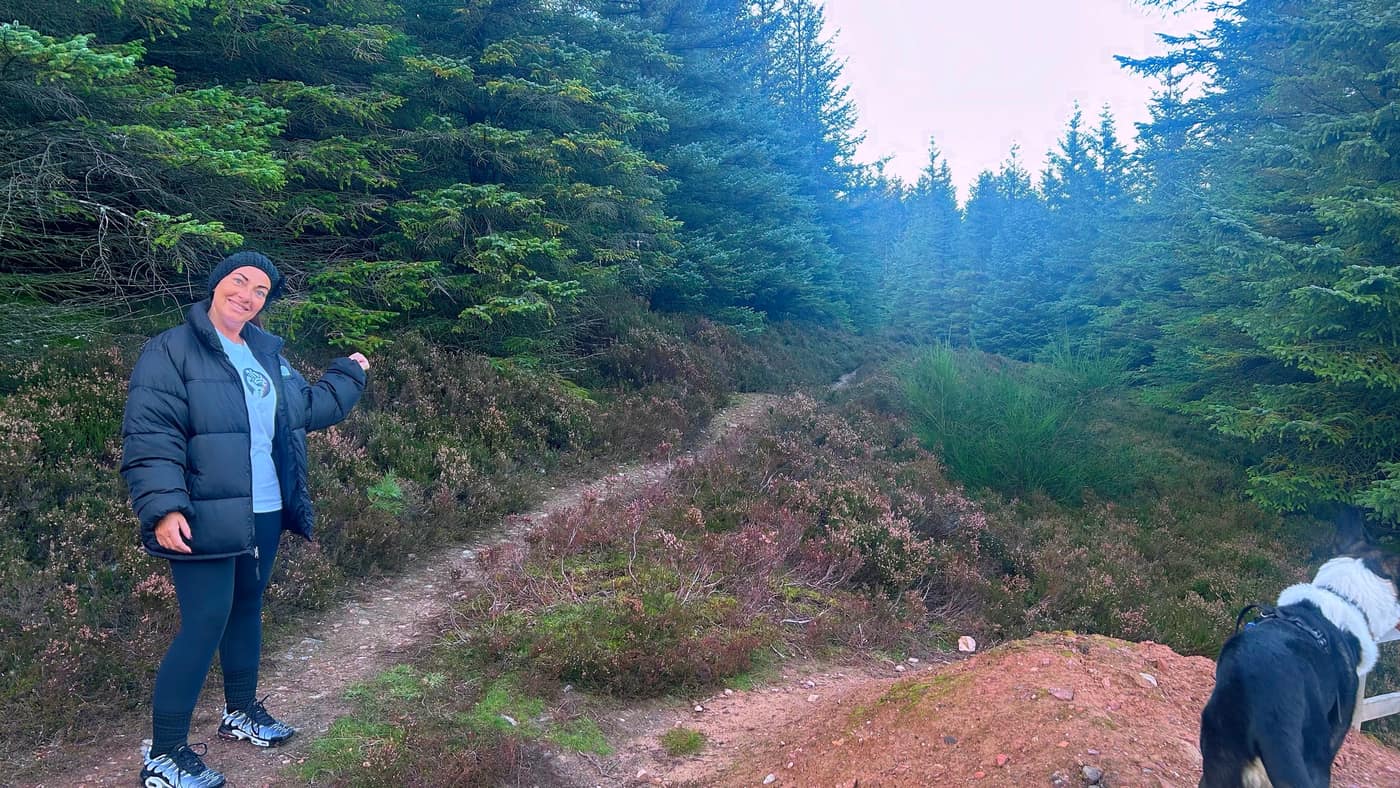 Katrina pointing out the right way at the top of the quarry path, Chase beside her