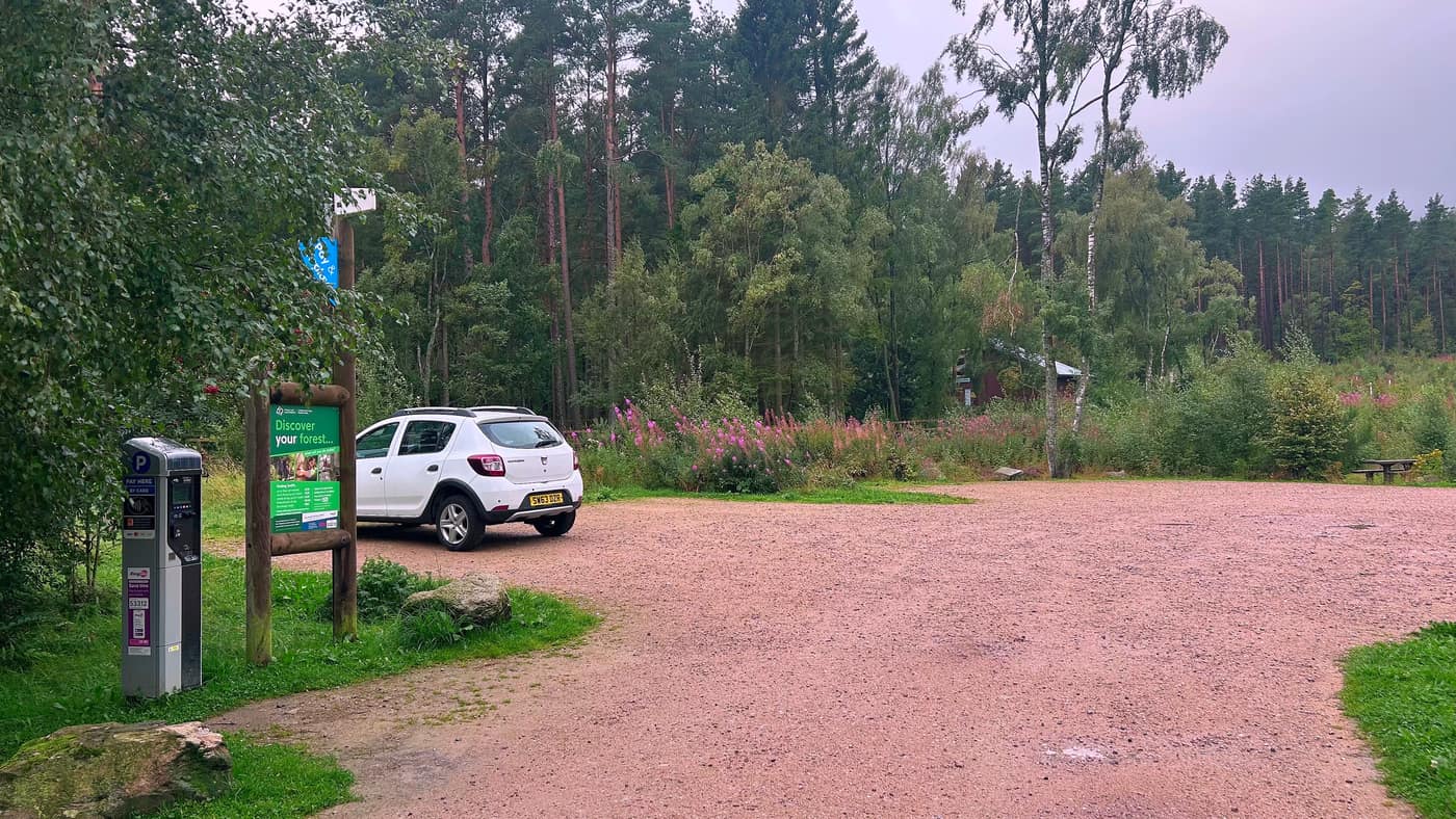 The gravel car park at the Bennachie Centre, with the pay and display machine at the edge of it