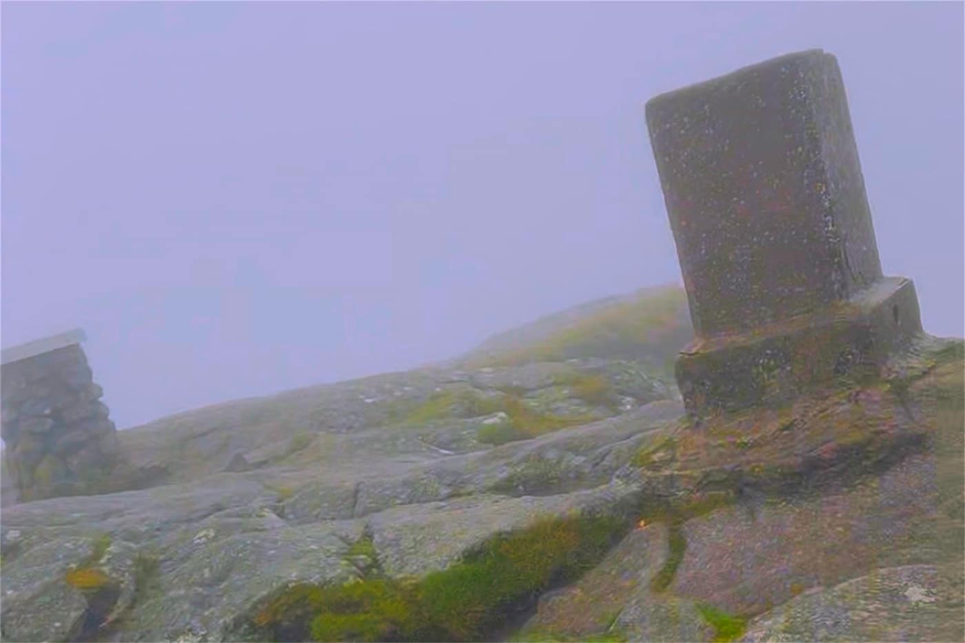 The trig pillar on the summit rocks, with the mist sitting right
behind it