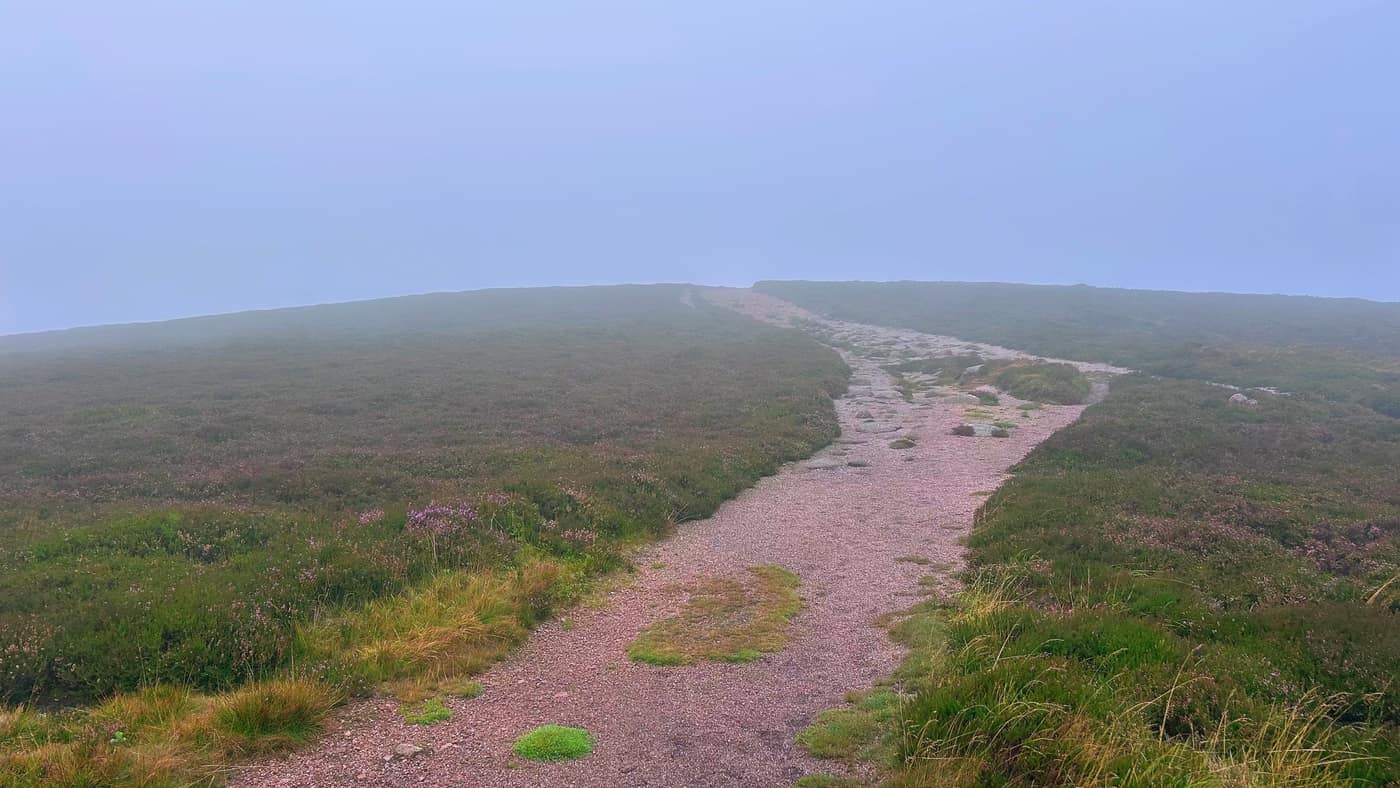 The path across the summit plateau disappearing into fog