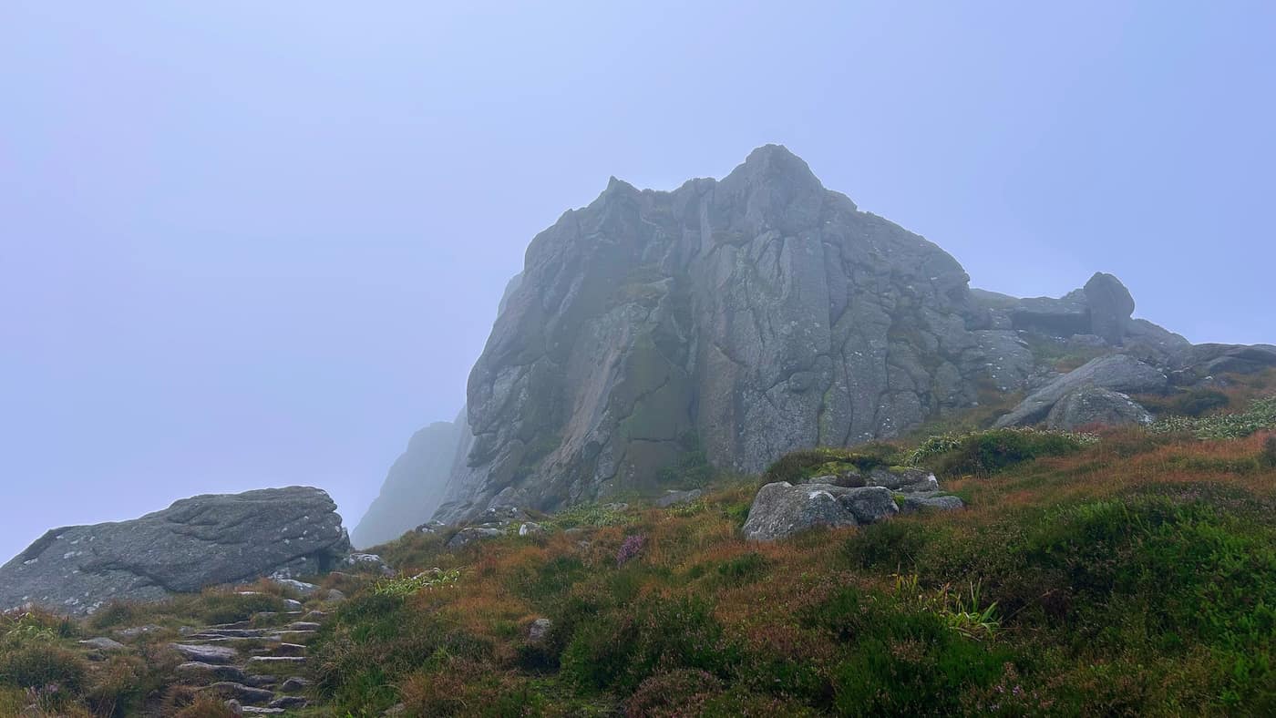 The granite tor showing through the mist for the first time