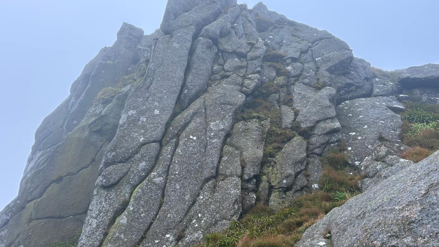 Looking up the cracked granite of the tor from underneath it