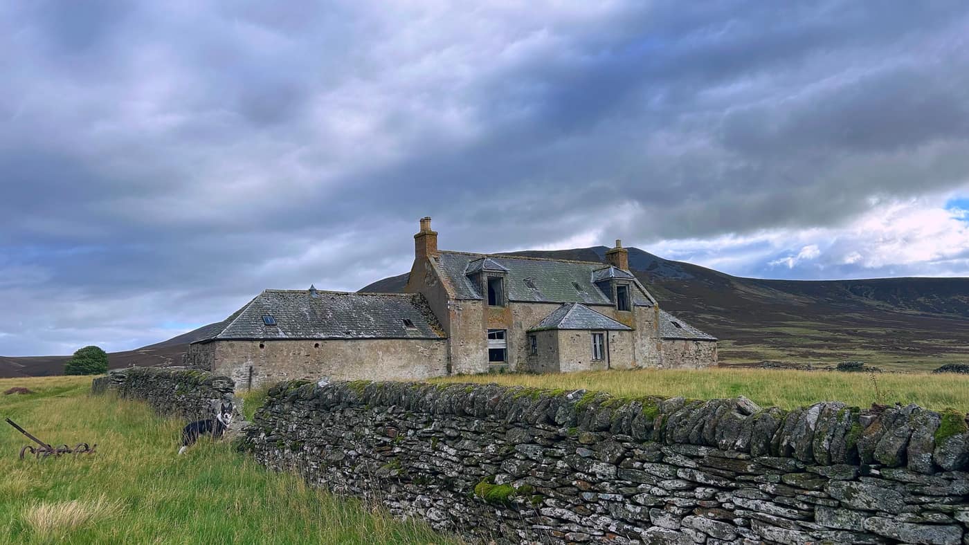 The first abandoned farmhouse, Chase settled in the grass by the
drystone wall