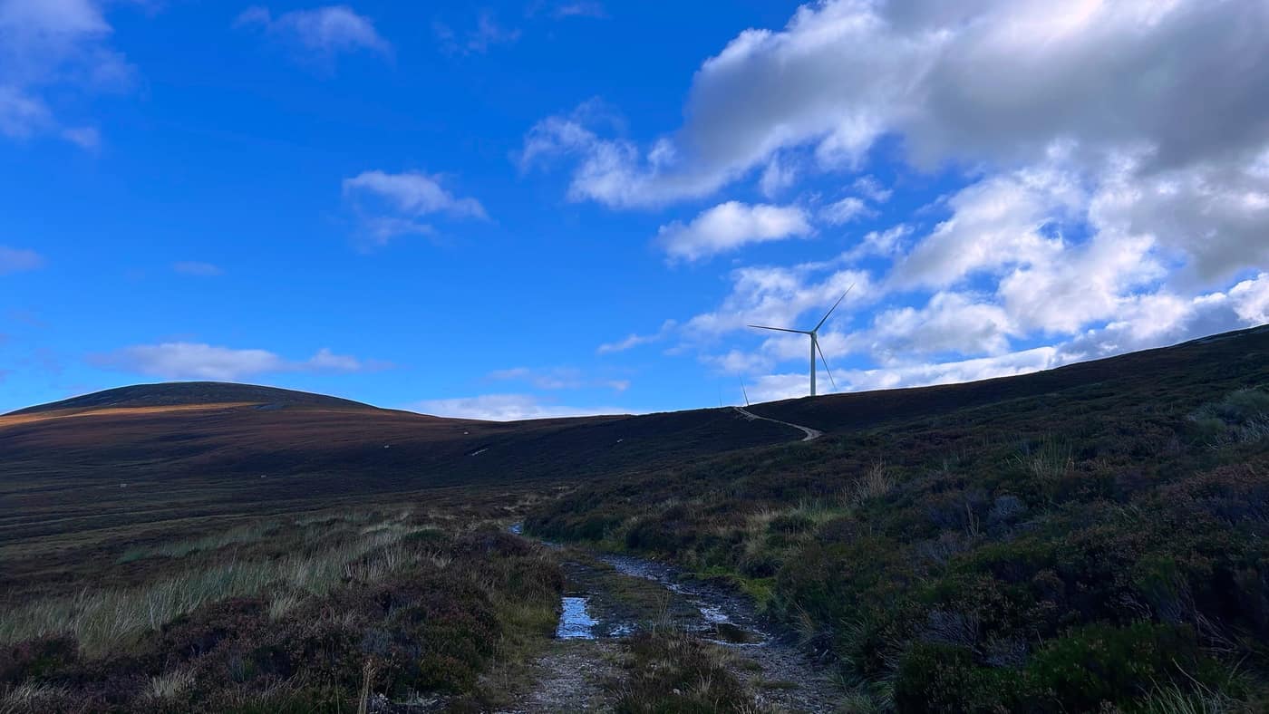 The first windmill showing over the ridge as the track climbs
