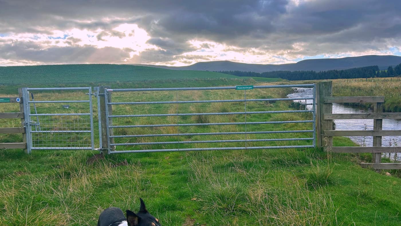 The gate to head for, with its Please shut the gate sign, the burn running past on the right