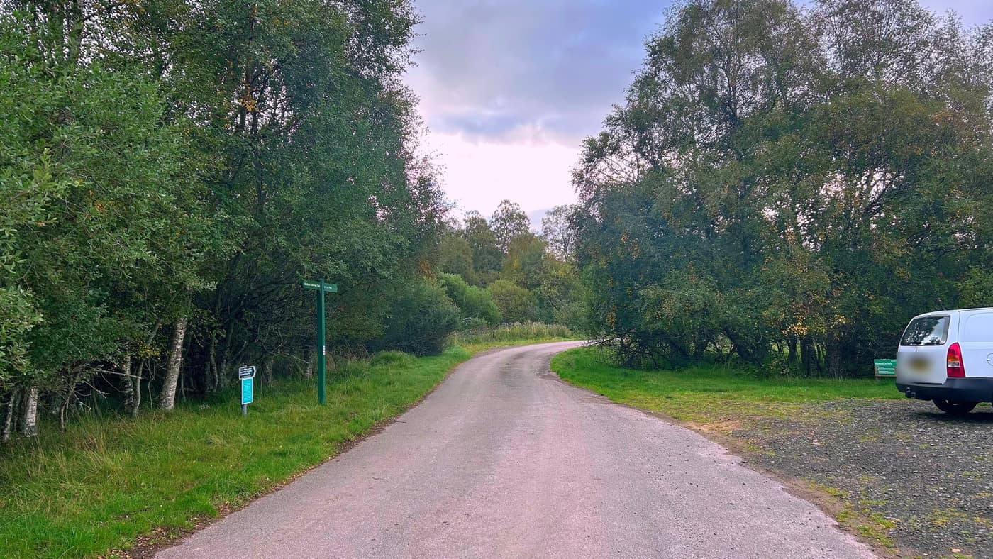 The road on from the car park, with the green estate fingerposts on
the left