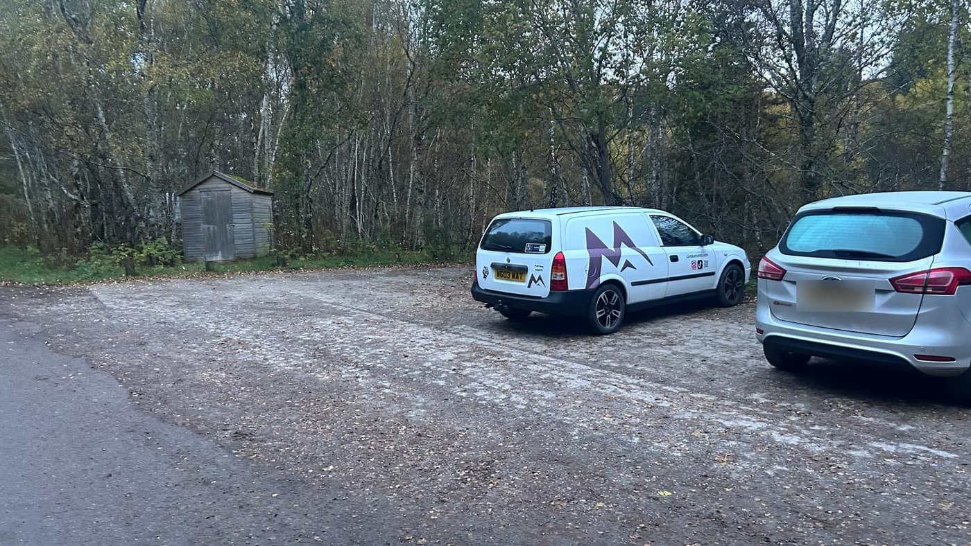The gravel car park at Silverbridge, the Climb A Munro van parked in it