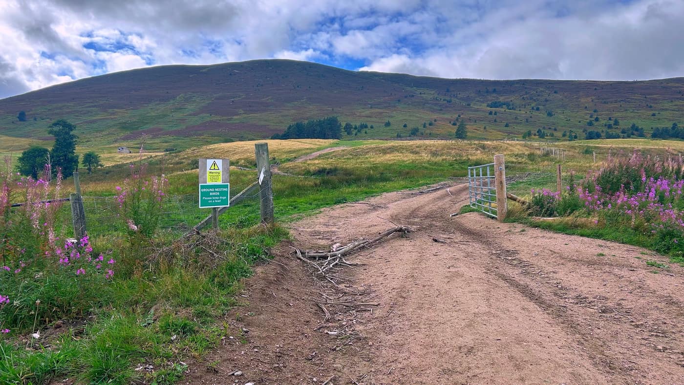 The gate at the start with the hill rising behind it