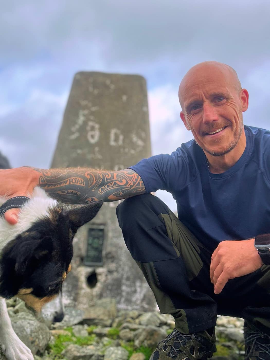 Me at the trig point with my arm round Chase