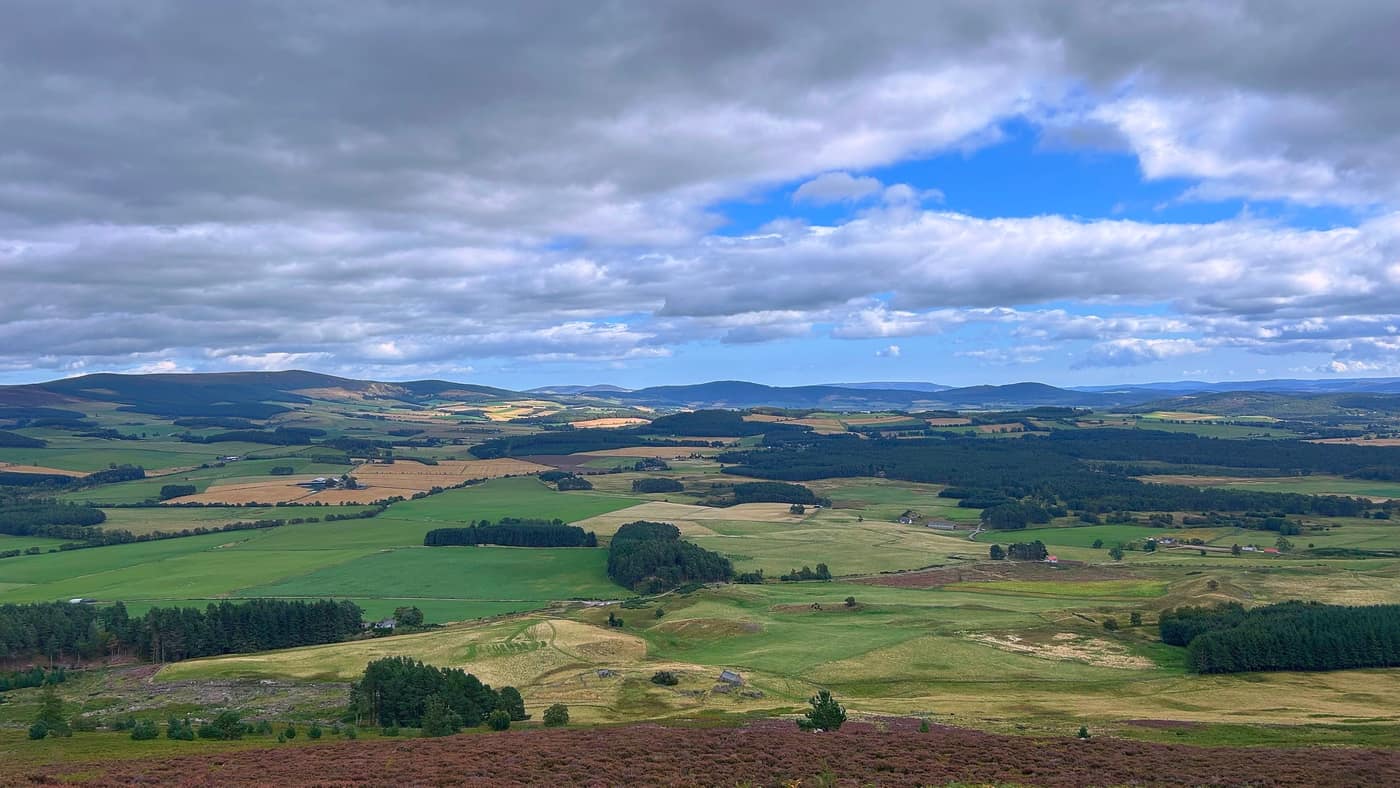 The wide view back over the farmland to the far hills