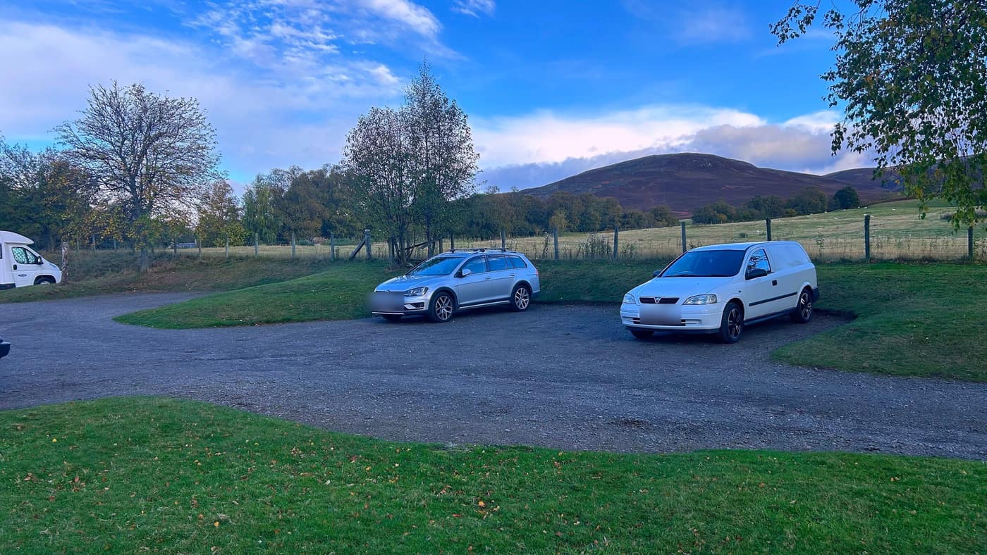 The gravel car park at Invermark, a motorhome and a couple of cars in it