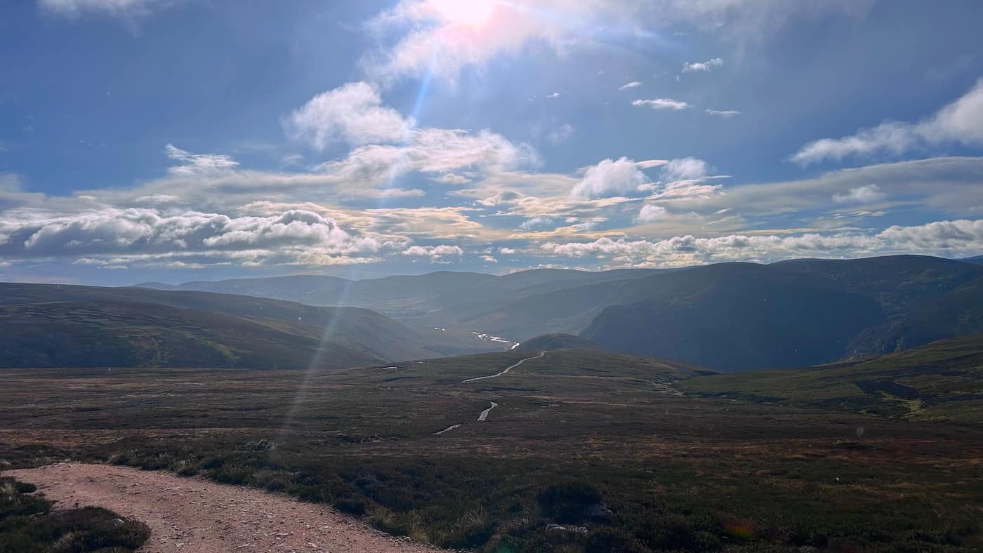 Looking back down over the moor into Glen Mark, the sun catching the track