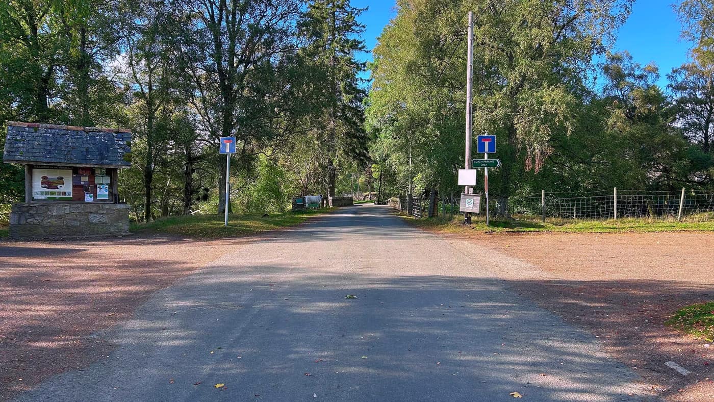 The end of the road at Invermark, dead-end signs either side and the information shelter on the left