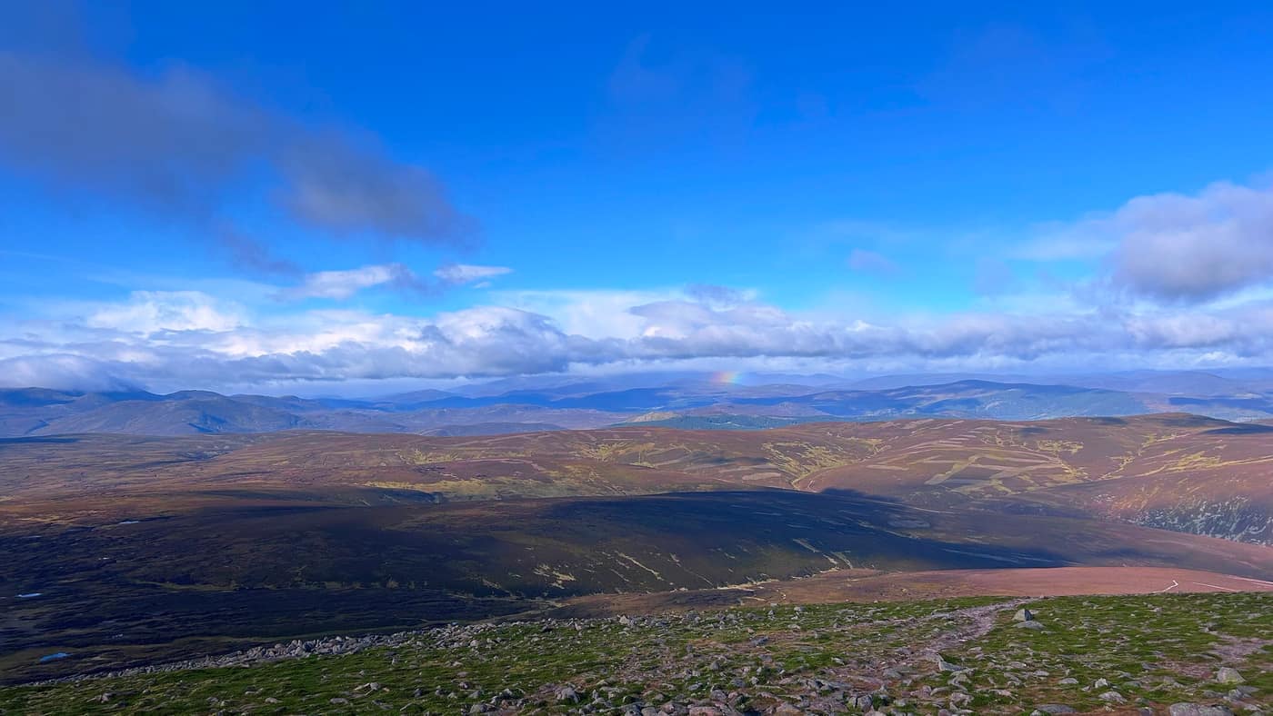 The view from the top with a faint rainbow out over the hills