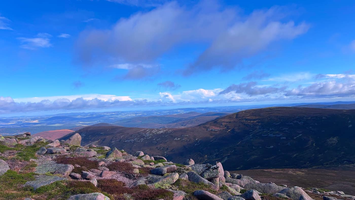 Pink granite boulders on the summit, the moors stretching out beyond