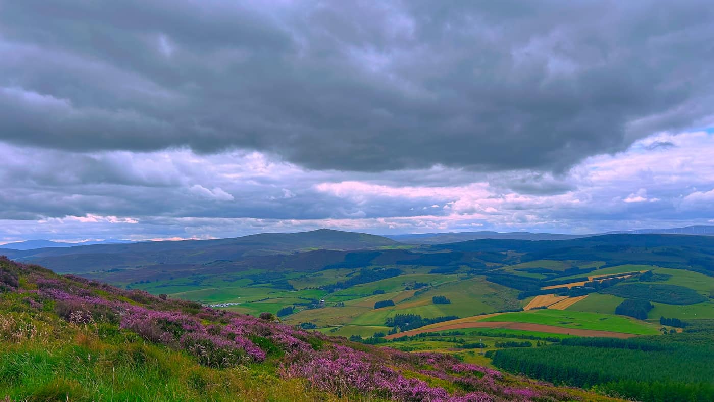 The valley below, with a pointed hill on the far skyline