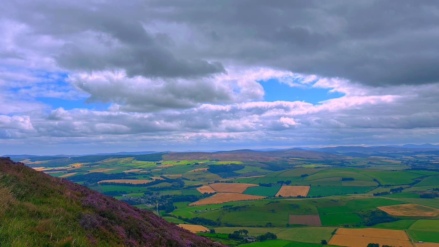 The village below, with the heather slope dropping towards it