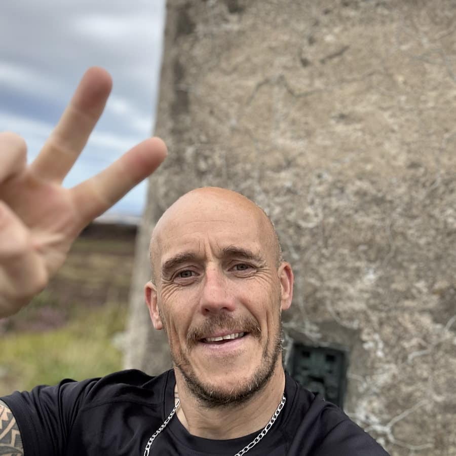 Ross at the trig point on Meikle Balloch Hill